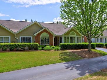 Charming single-story home featuring manicured landscaping, a brick facade, and a well-maintained lawn at 106 Vintage Club Cir, Marietta, GA 30066