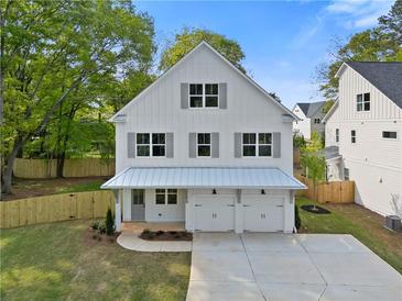 Charming two-story home with white siding, gray shutters, and a well-manicured lawn at 1576 Hawthorne Se Ave, Smyrna, GA 30080