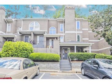 Attractive townhouse with manicured landscaping, covered entry, and convenient parking at 59 Saint Claire Ne Ln, Atlanta, GA 30324