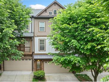 Charming townhome showcasing a well-manicured lawn, a garage, and a beautiful architectural design at 3231 Chutney Ct, Avondale Estates, GA 30002