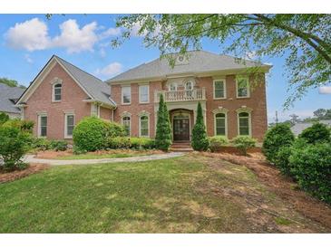 Stately brick home with manicured front lawn, covered balcony and prominent entrance at 3689 Spring Hill Se Rd, Smyrna, GA 30080