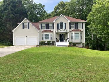 Traditional two-story home with a well-manicured lawn and inviting front entrance at 2257 Rocksram Ct, Buford, GA 30519