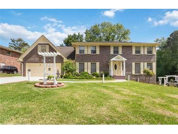 Charming two-story brick home with a well-manicured lawn and inviting curb appeal at 5152 Clearwater Dr, Stone Mountain, GA 30087