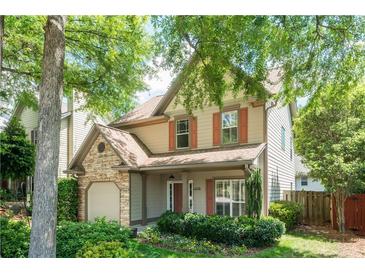 Charming two-story home with a stone-accented garage and a beautifully landscaped front yard at 1115 Third St, Stone Mountain, GA 30083