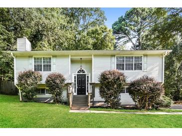 Charming home featuring lush landscaping, a cozy entrance, and a well-maintained front yard at 2636 Suzanne Ln, Acworth, GA 30102