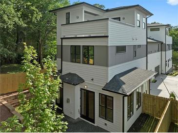 Stunning exterior elevation showcasing a modern, three-story home with white and gray siding and black-framed windows at 90 Cleveland Unit B Se St, Atlanta, GA 30316