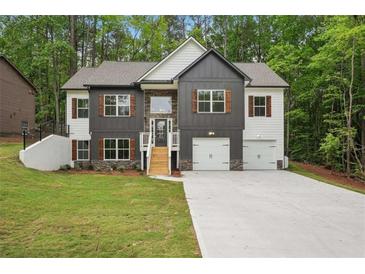 Two-story home boasts a two-car garage, attractive curb appeal, and well-maintained landscaping at 2279 Lakeview Pkwy, Villa Rica, GA 30180