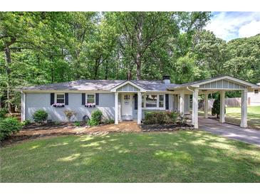 Charming single-story home with a welcoming front yard and a covered carport at 3710 Lavilla Dr, Powder Springs, GA 30127