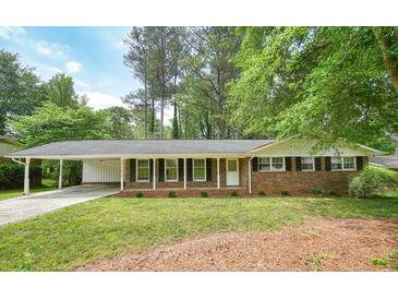Charming brick home with a covered carport and manicured lawn, perfect for suburban living at 2350 Maxine Se Dr, Marietta, GA 30067