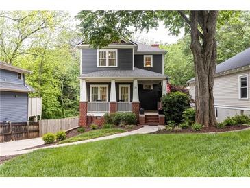 Charming two-story home with a inviting front porch and well-manicured lawn at 79 Anniston Se Ave, Atlanta, GA 30317