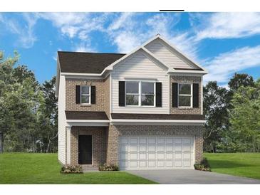 Charming two-story home with a brick and white siding, a two-car garage, and a well-maintained lawn at 1245 Elowen Dr, Austell, GA 30168