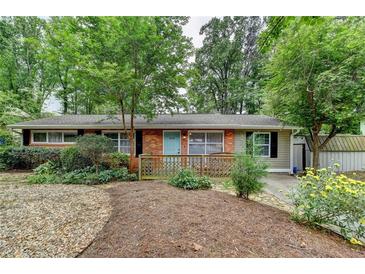 Charming single-story home with brick accents, lovely front yard, and inviting light blue front door at 3081 Anthony Dr, Decatur, GA 30033
