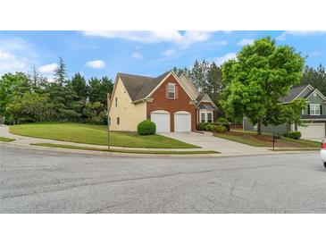 Inviting two-story home featuring a brick facade and a well-manicured lawn at 481 Jefferson Chase Se Cir, Atlanta, GA 30354