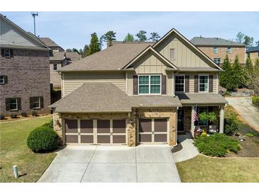 Charming home featuring a well-manicured lawn, attached two-car garage and traditional architectural details at 2906 Ansley Manor Ct, Marietta, GA 30062
