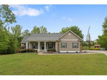 Charming single-story home with a covered front porch and well-manicured lawn at 109 J O Simmons Path, Douglasville, GA 30134
