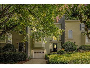 Charming two-story townhouse with lush landscaping, a one-car garage, and inviting curb appeal for comfortable living at 27 Sycamore Sta, Decatur, GA 30030