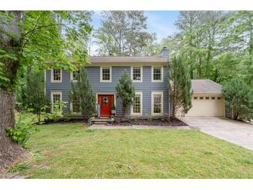 Charming two-story home with a well-manicured lawn and a vibrant red front door at 2910 Edwards Ct, Marietta, GA 30068