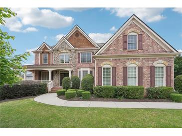 Stunning two-story brick home with manicured lawn and stone accents, exuding curb appeal at 1888 Sever Creek Cir, Lawrenceville, GA 30043