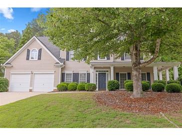 Charming two-story home with a well-manicured front yard and inviting entrance at 6131 Windflower Dr, Powder Springs, GA 30127