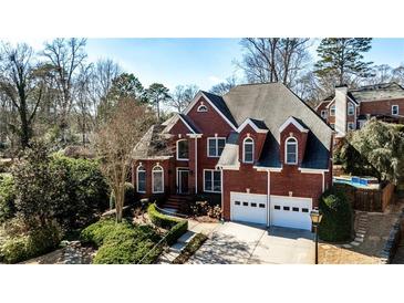 Charming two-story brick home featuring a well-manicured front yard and a two-car garage at 389 Mill Creek Ne Bnd, Atlanta, GA 30307