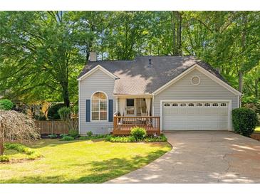 Charming single-story home with a well-maintained lawn and a two-car garage at 1025 Taylor Oaks Dr, Roswell, GA 30076