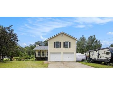 Charming two-story home featuring a two-car garage and a lovely front porch in a suburban setting at 2730 Milton Bryan Dr, Loganville, GA 30052