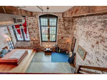 Spacious bedroom with exposed brick wall, large window and industrial chic design at 170 Boulevard # H201, Atlanta, GA 30312