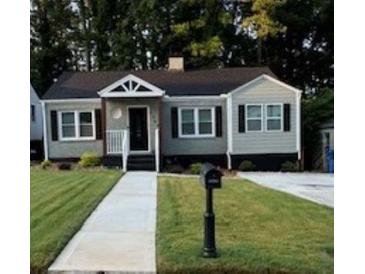Charming one-story home with a well-manicured lawn and inviting walkway to the front door at 1740 Emerald Ave Ave, Atlanta, GA 30310