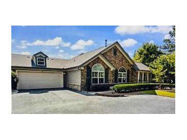 Charming single-story home featuring stone accents, a two-car garage, and well-maintained landscaping at 104 Highlands Ridge Se # 1, Smyrna, GA 30082