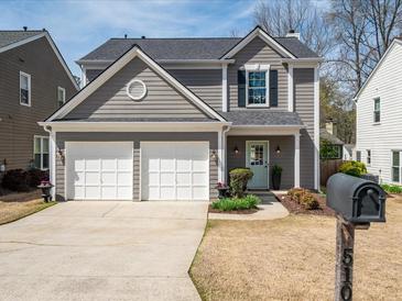Charming two-story home with a well-manicured lawn and a two-car garage at 510 Rosedown Way, Alpharetta, GA 30022