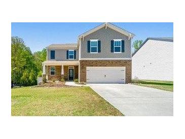 Charming two-story home with a well-manicured lawn and attached two-car garage at 6900 Oak Valley Dr, Douglasville, GA 30134