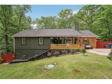 Charming home with a welcoming porch and landscaped front yard perfect for outdoor enjoyment at 1490 Ashbrook Dr, Lawrenceville, GA 30043