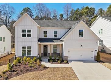 Charming two-story home with white siding, manicured landscaping, and inviting front porch at 2865 Ferncliff St, Cumming, GA 30028