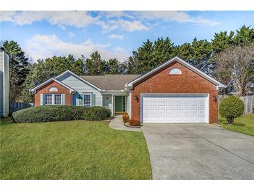 Charming single-story home with well-manicured lawn, brick accents, and a two-car garage at 4124 Berwick Farm Dr, Duluth, GA 30096