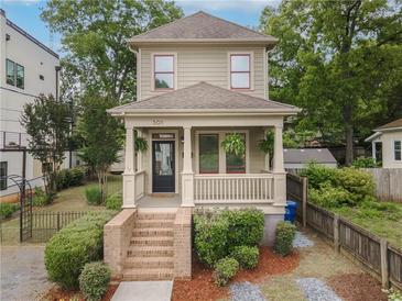 Charming two-story home featuring a welcoming front porch, landscaped yard, and well-maintained exterior at 301 Fortune Ne St, Atlanta, GA 30312