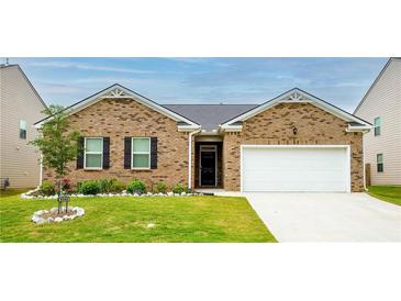 Charming single-story brick home with manicured lawn and attached two-car garage at 5344 Flat Rock Pt, Stonecrest, GA 30038