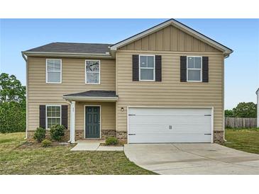 Charming two-story home with tan siding, black shutters, and an attached two-car garage at 33 Oxford Ln, Kingston, GA 30145