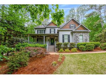 Charming two-story home featuring a covered front porch and well-manicured landscaping at 529 Wintergreen Way, Canton, GA 30115