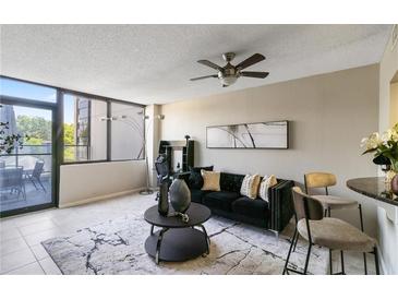 Stylish living room featuring a black sofa, modern decor, and a ceiling fan for added comfort at 1280 W Peachtree Nw St # 810, Atlanta, GA 30309