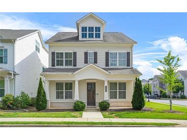 Charming two-story home with neutral siding, dark shutters, manicured lawn and welcoming front porch at 1436 Belmont Ave, Smyrna, GA 30080