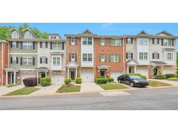 Charming townhomes with manicured lawns, attached garages and unique curb appeal at 3094 Lauren Parc Rd, Decatur, GA 30032