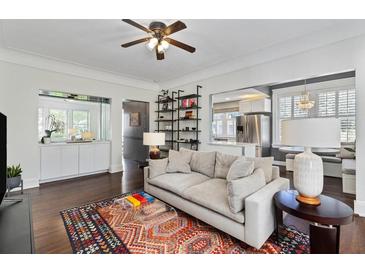 Bright living room features hardwood floors, ceiling fan, and large sofa at 301 10Th Ne St # 12, Atlanta, GA 30309