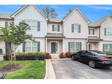 Charming townhouse with well-maintained landscaping, flowerbeds, and private driveway at 7762 Fawn Cir, Covington, GA 30014