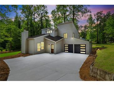 Striking modern home with a unique architectural design, pristine landscaping, and attached two car garage at 2934 Wendover St, Marietta, GA 30062