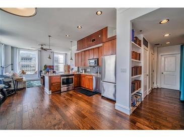 Open kitchen features stainless steel appliances, hardwood floors, and seamless integration to the living area at 57 Forsyth Nw St # 12B, Atlanta, GA 30303