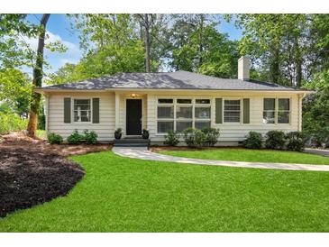 Charming single-story home featuring a well-manicured lawn, a stone walkway, and a classic, welcoming facade at 960 Lindridge Ne Dr, Atlanta, GA 30324