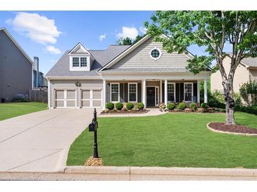 Charming single-Gathering home with a beautifully landscaped front yard and inviting front porch at 100 Inspiration Ln, Dallas, GA 30157