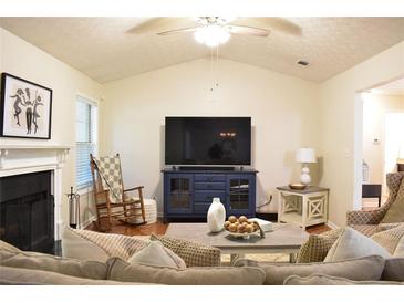 Cozy living room with fireplace, rocking chair, and large-screen television at 1676 Northridge Dr, Morrow, GA 30260