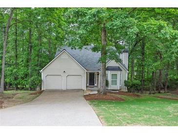 Charming single-Gathering home with a two-car garage, surrounded by mature trees and landscaping at 1922 Knipe Sw Dr, Marietta, GA 30064