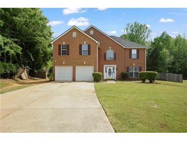 Charming two-story brick home with a well-manicured lawn, two-car garage and mature trees at 1314 Durham Ter, Mcdonough, GA 30252
